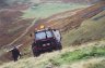  - Myself with my 6 wheel drive outfit marking out a fence line. This was extremely steep and very dangerous as the hill face was loose scree - a bit like marbles.  Chains were an absolute necessity as a rubber tyred outfit would have been like a death trap.